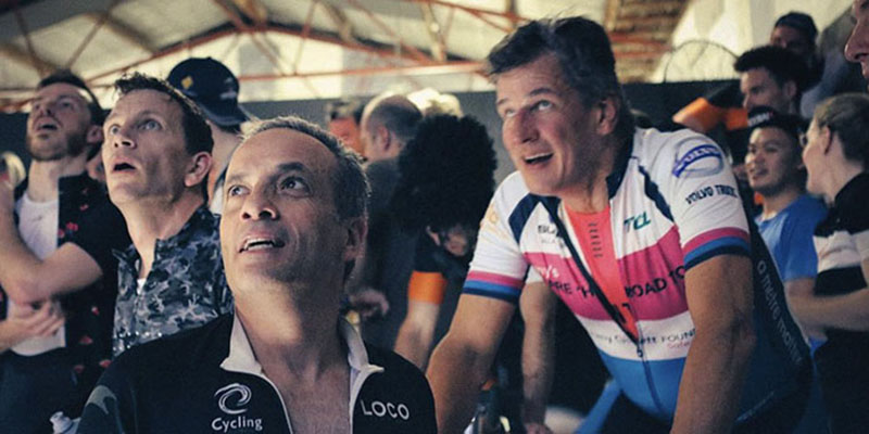 Indoor cycling riders looking at scoreboard