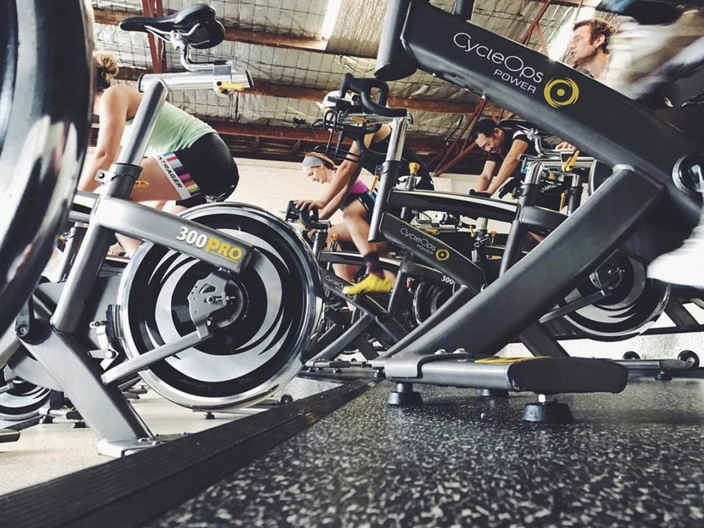 Low view of riders in Cycle Collective class